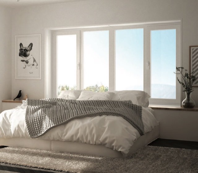 VEKA catalogue reference image of white uPVC casement windows in a softly lit bedroom